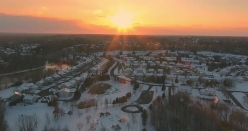 Aerial Top View Townhouse Settlement in Winter Snow Covered Rooftops of Cottages