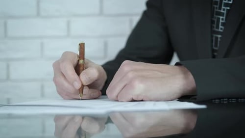 Executive Signing Documents at Modern Desk