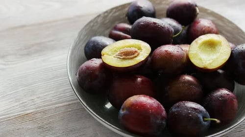 Bowl of Fresh Plums in Daylight