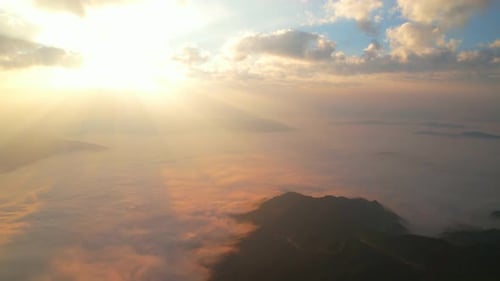 Aerial view from drone, Epic sunbeam over sea of clouds mountains. 4K aerial shot on sunrise