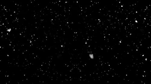 Falling Snow Against Black Background Creates Winter Mood