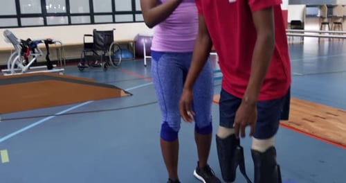 Physical Therapy with Prosthetic Legs in a Gym