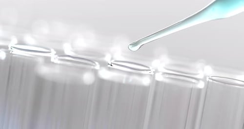 Liquid Being Dropped into a Test Tube Rack