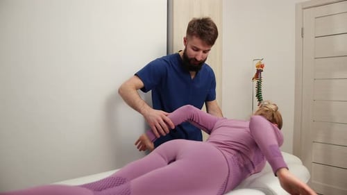 Physical Therapist Massaging Woman's Neck and Back