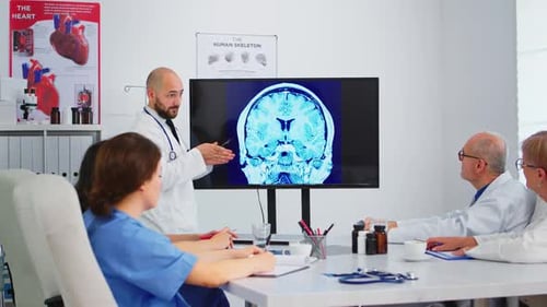 Medical Professionals Discussing Brain Scan in Office