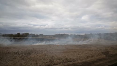 Aerial View of Dry Grass Burning on the Farmland