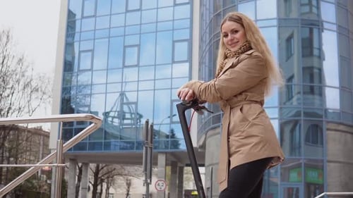 Woman Poses with Electric Scooter in City
