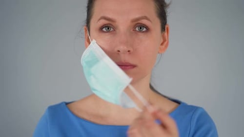Pandemic Protection of the Covid-19 Coronavirus. Caucasian Woman in a Medical Face Mask. Virus
