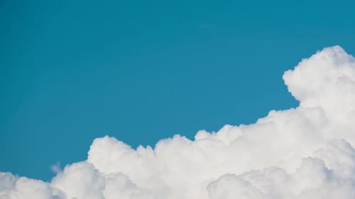 Clouds Moving Slowly Across Blue Sky During Daytime