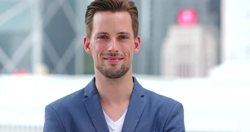 Smiling Man in Blazer Close-Up in Urban Setting