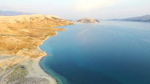 Aerial view of turquoise sea and yellow grass of Pag island, Croatia