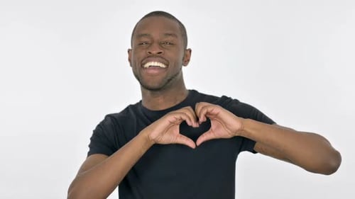 Man Smiling and Making Heart Shape with Hands