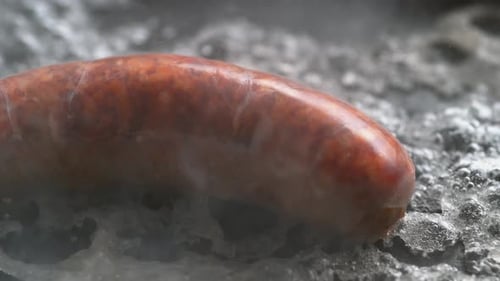 Sausage Cooking Close-Up with Bubbles and Smoke