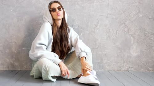 Stylish Woman Posing with Peace Sign Indoors