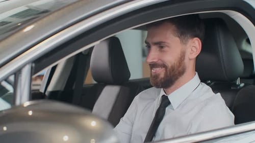 Smiling Man Sitting Inside New Car