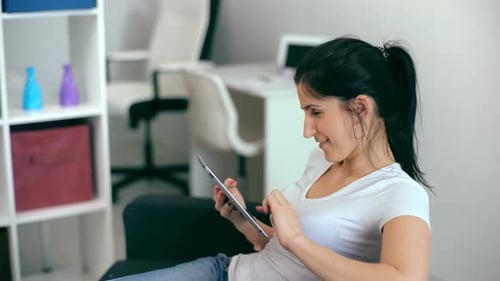 Woman Using Tablet Device in Bright Modern Home