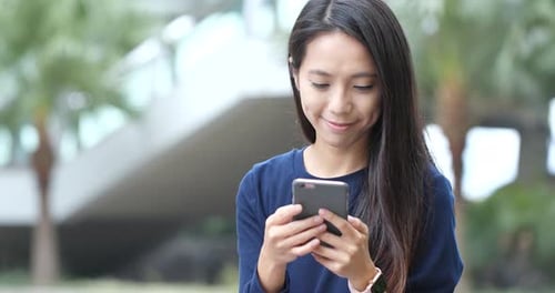 Woman Using Smartphone in Urban Environment
