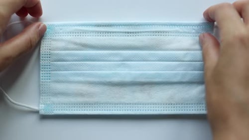 Hands Reveal 'Welcome Home' Message After Mask Removal