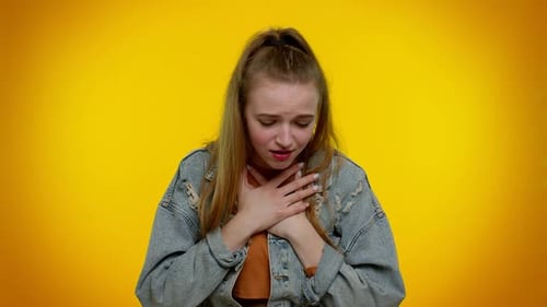 Young Woman Experiencing Pain Touching Head and Chest