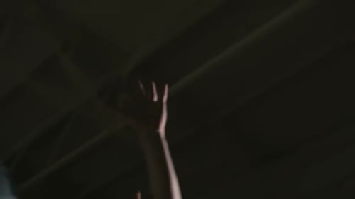 Young Adults Play Basketball on Indoor Court