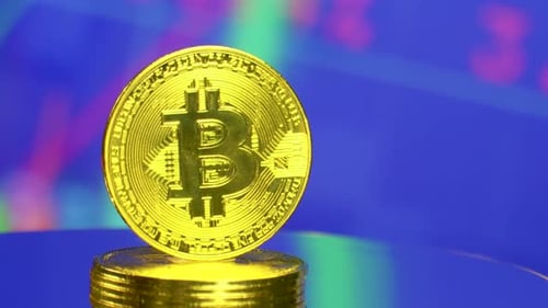 Rotating Bitcoin Coins Stack on Reflective Surface