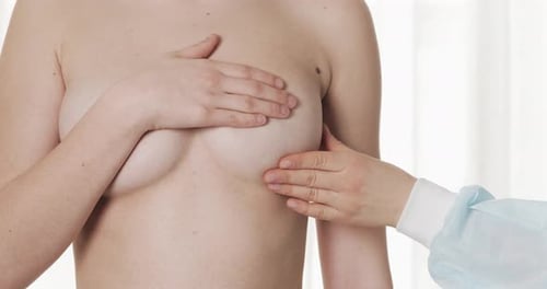 Doctor Checking Woman's Breast at Hospital. Breast Cancer Prevention