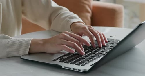 Close Up of Hands Typing on Laptop Keyboard