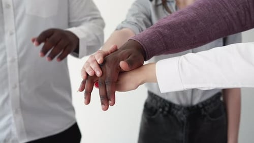 Diverse Team Hands Stacking in Business Setting
