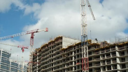 Tower Cranes Operate at Construction Site of New Building