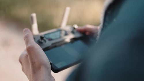 Person Controls Drone with Handheld Device