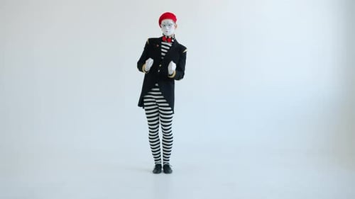 Slow Motion of Male Mime Artist Dancing Moving Arms Looking at Camera Against White Background