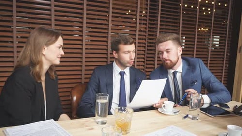 Business Team Collaborating on Documents in Office