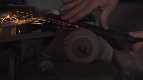 Worker Grinding Metal with Sparks Flying Close Up
