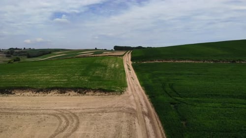 Aerial View of Green Farmland with Rural Road