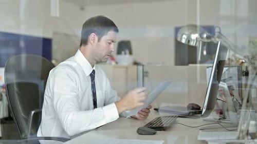 Stressed Man Working at His Desk in Office