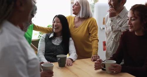 Friends Chatting and Laughing Together at Table