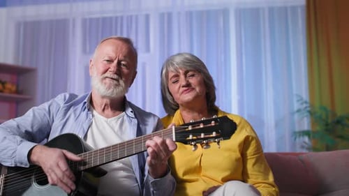 Senior Couple Playing Guitar and Singing Together