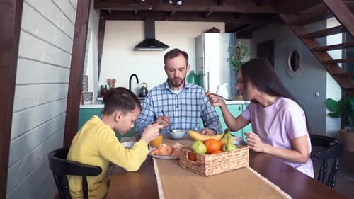 Family Together Enjoying Breakfast in Bright Home Kitchen