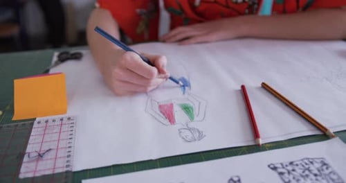 Caucasian woman drawing in fashion office