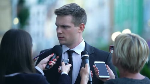 Young Adult Man Giving Interview in Urban Setting