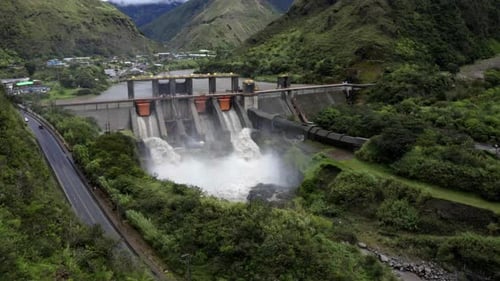 Aerial side view, flying towards a large hydroelectric dam