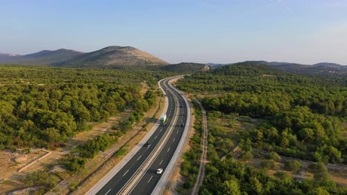 Aerial view on road. Highway through mountain valley. View from a drone.