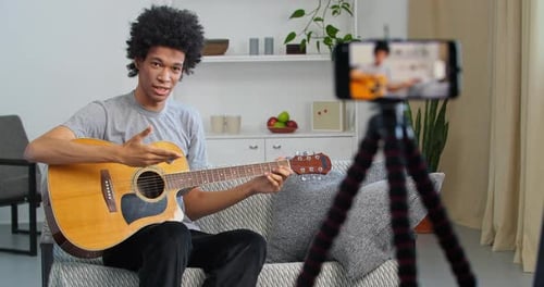 Young Adult Vlogging Guitar Tutorial Indoors