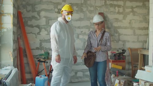 Engineers Discussing Construction Project in Urban Building