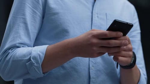 Person Using Smartphone in Urban Setting