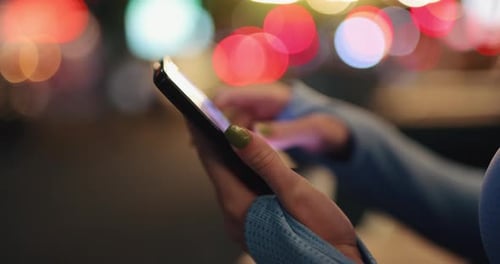 Women Hands Using Browsing Smartphone at the Night City