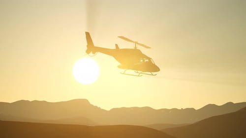 Helicopter Flight Over Mountains During Sunset