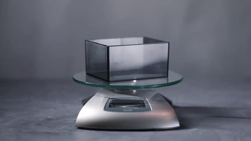 Coffee Beans Poured Into Container On Top Of Scale