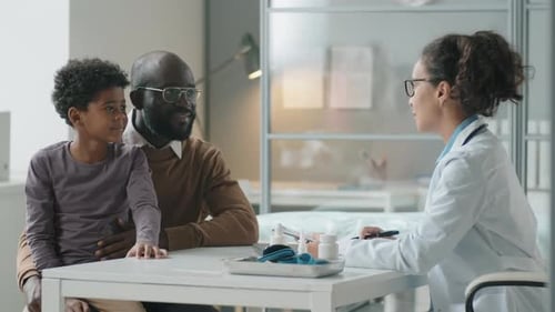Child with Adult at Cheerful Doctor's Appointment