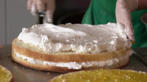 Cake Layers Frosted in Busy Kitchen